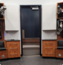 Locker room media cabinets frame a doorway