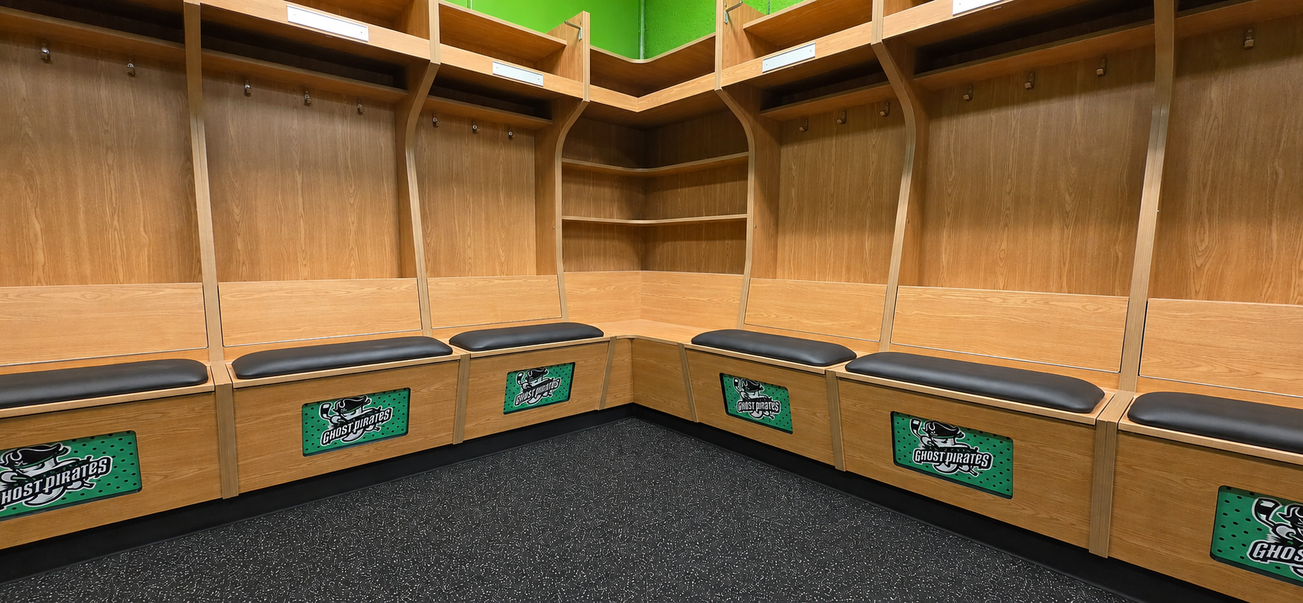 Photo of custom hockey locker room with corner shelf.